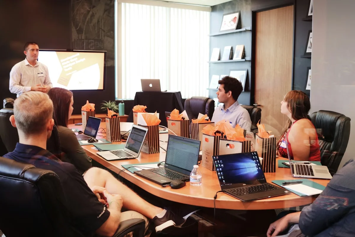 Consultant presenting digital strategy to a team around a conference table